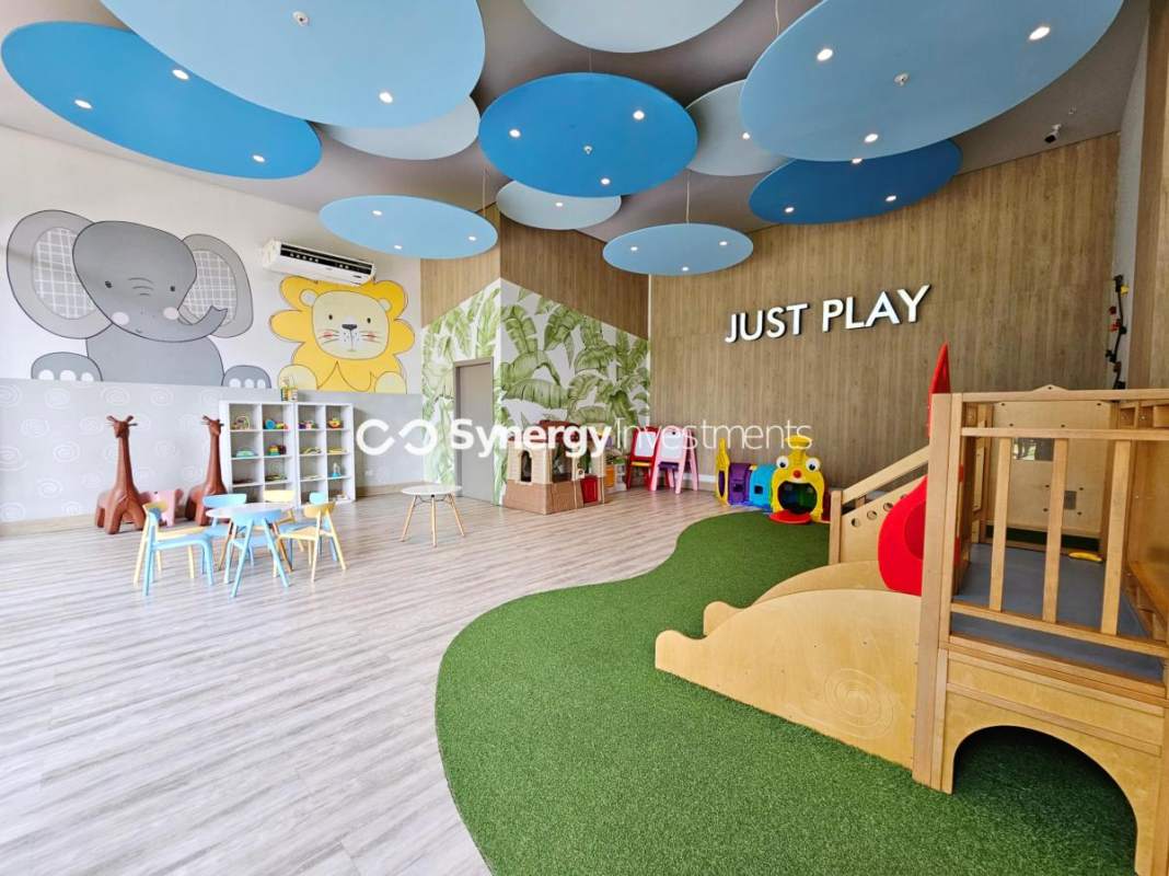 Bright kids' playroom with murals, slide and toys in PH Costa del Este Prime residences Panama