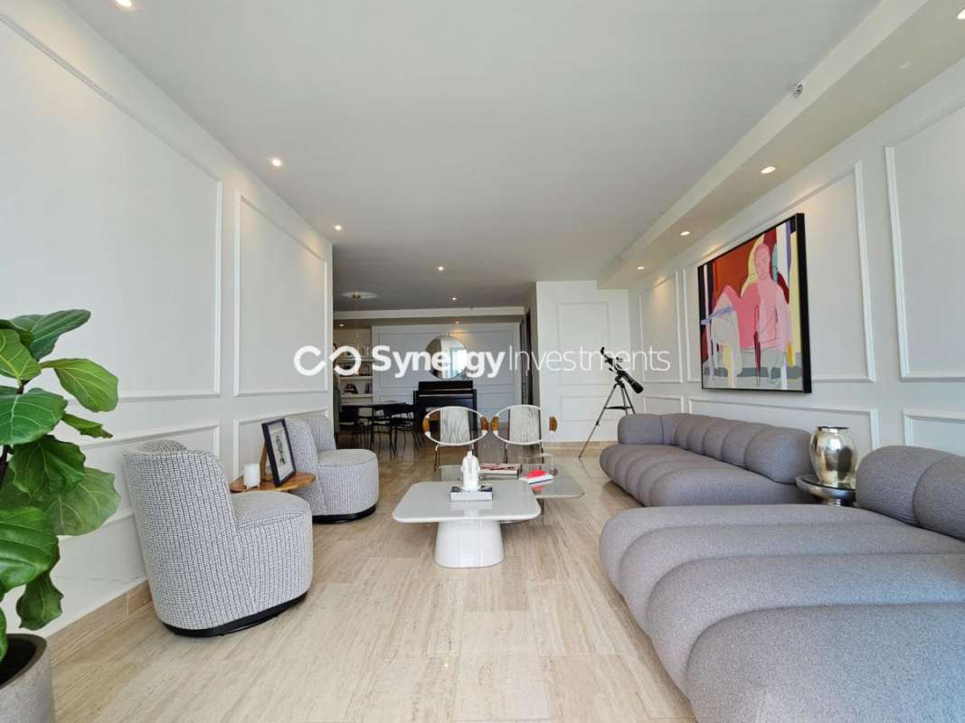 Modern dining area with round table, marble flooring and piano in PH Costa del Este Prime Panama