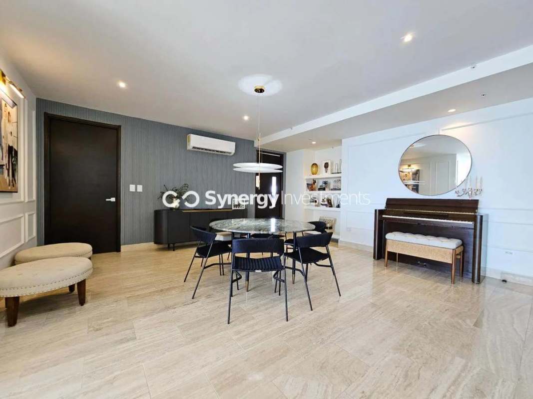 Luxury bedroom with king bed, ocean view window, flat-screen TV in PH Costa del Este Prime Panama