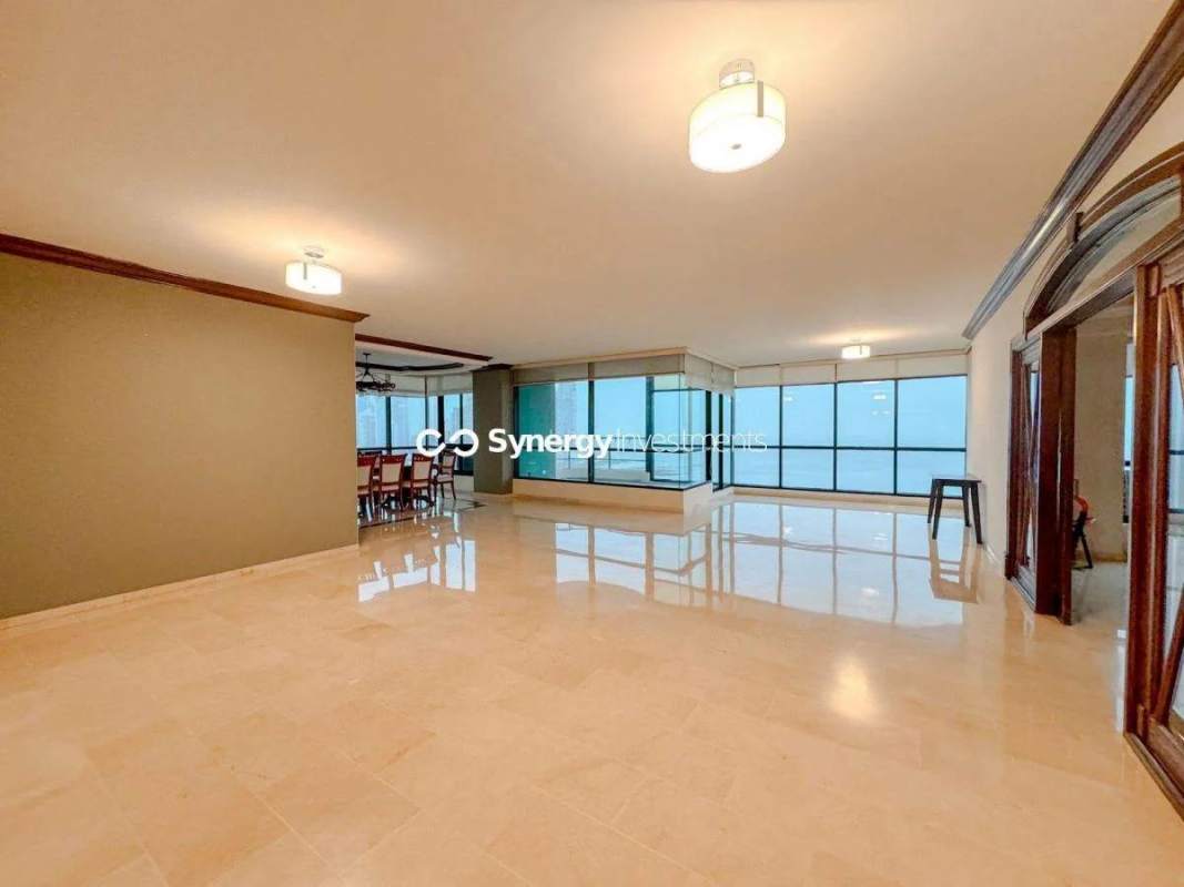 Spacious living room with floor-to-ceiling windows, marble flooring, city ocean views in PH Miramar Panama City