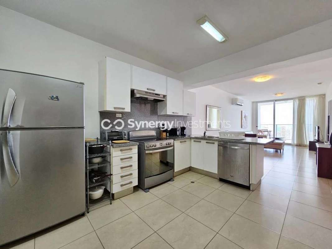 Modern open kitchen with granite counters and appliances in PH White Avenida Balboa