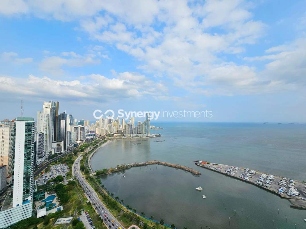 Furnished master bedroom featuring walk-in closet, ocean view, and ensuite in PH White Tower Avenida Balboa
