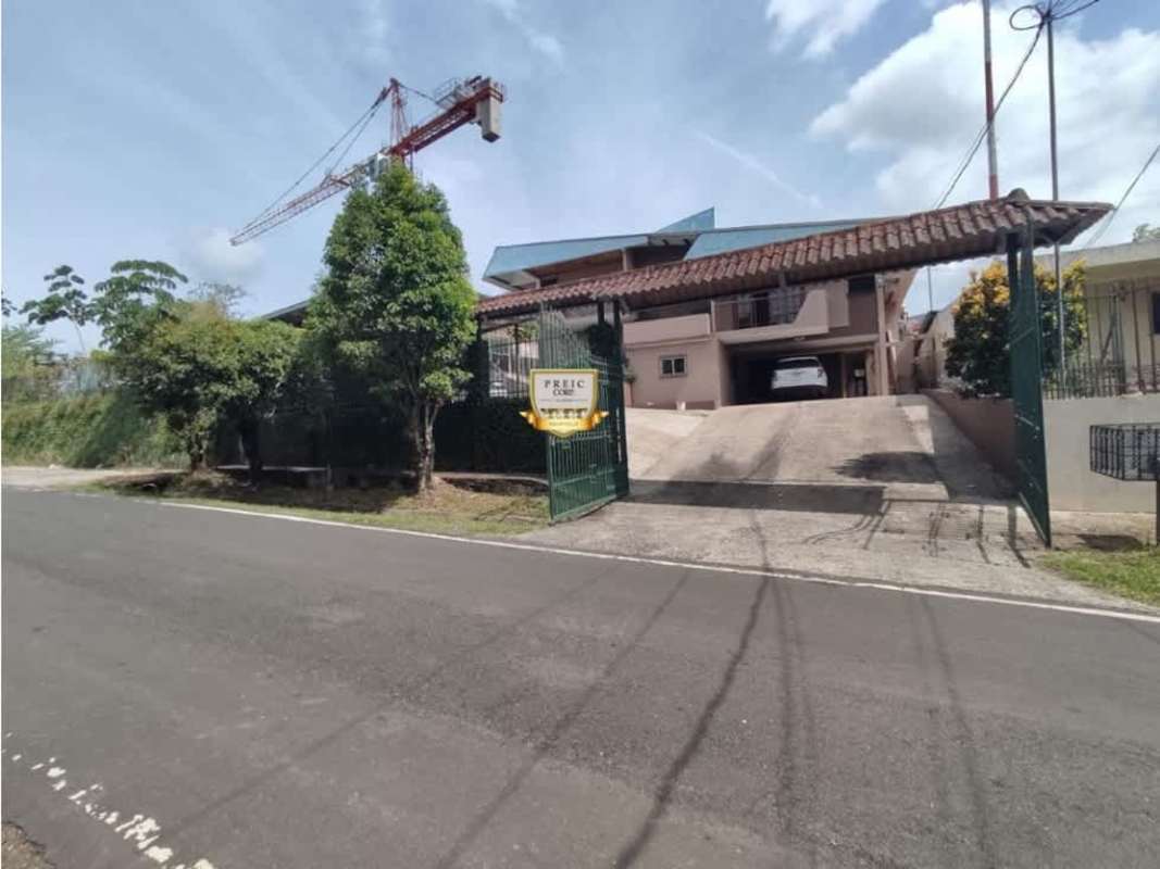 Open kitchen with breakfast bar and wood cabinetry Villa Zaita Panama house for sale