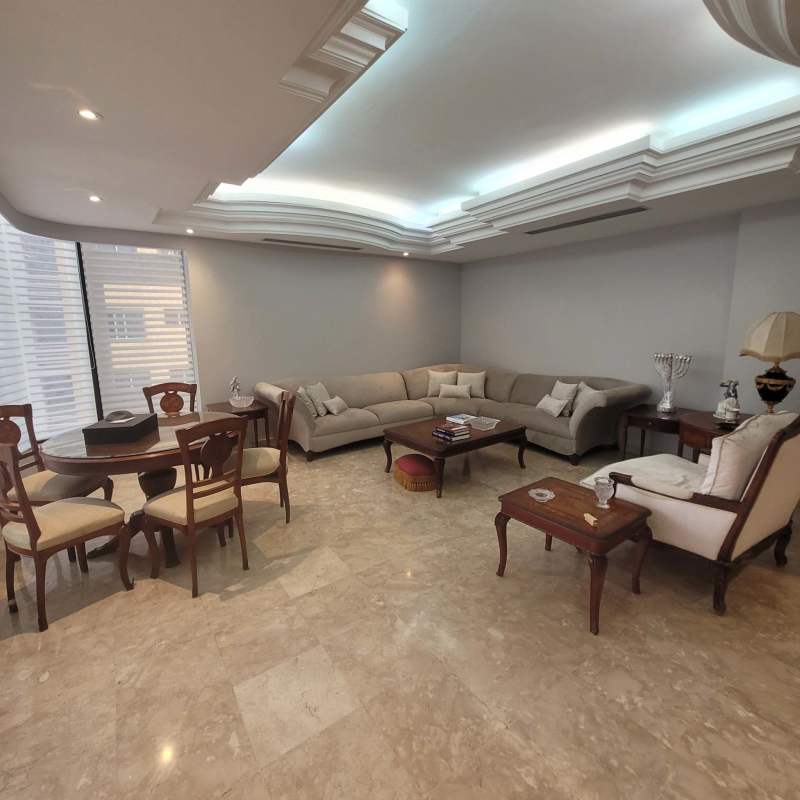 Open-plan living dining room, marble floors, luxurious decor in premium Punta Paitilla penthouse
