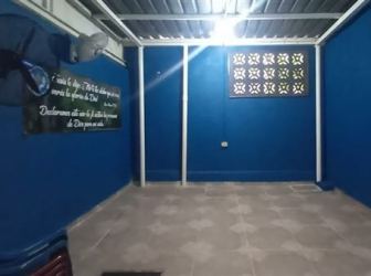 Enclosed entryway with blue walls metal security bars townhouse Arraiján Panama