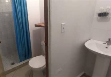 Simple room with blue walls, ventilation block window and tiled floor in Arraiján Panama