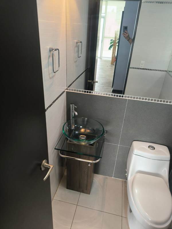 Modern bathroom with glass enclosed shower and vanity in PH Quadrat Panama