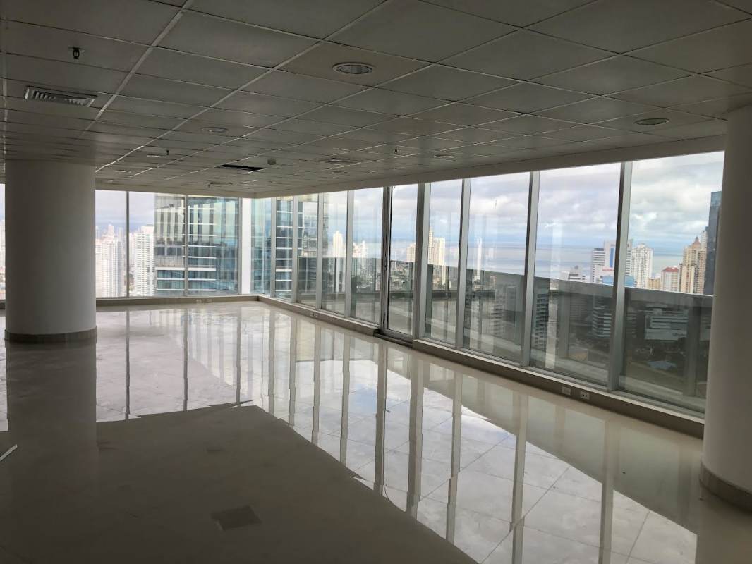 Two adjacent restrooms with pedestal sinks inside office space Revolution Tower Panama