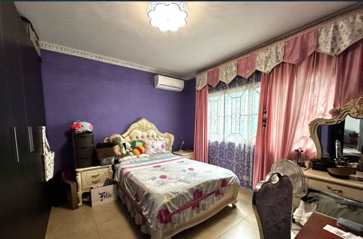 Master bedroom with purple accent wall, ornate bed, mirrored vanity Dorado Village Panama
