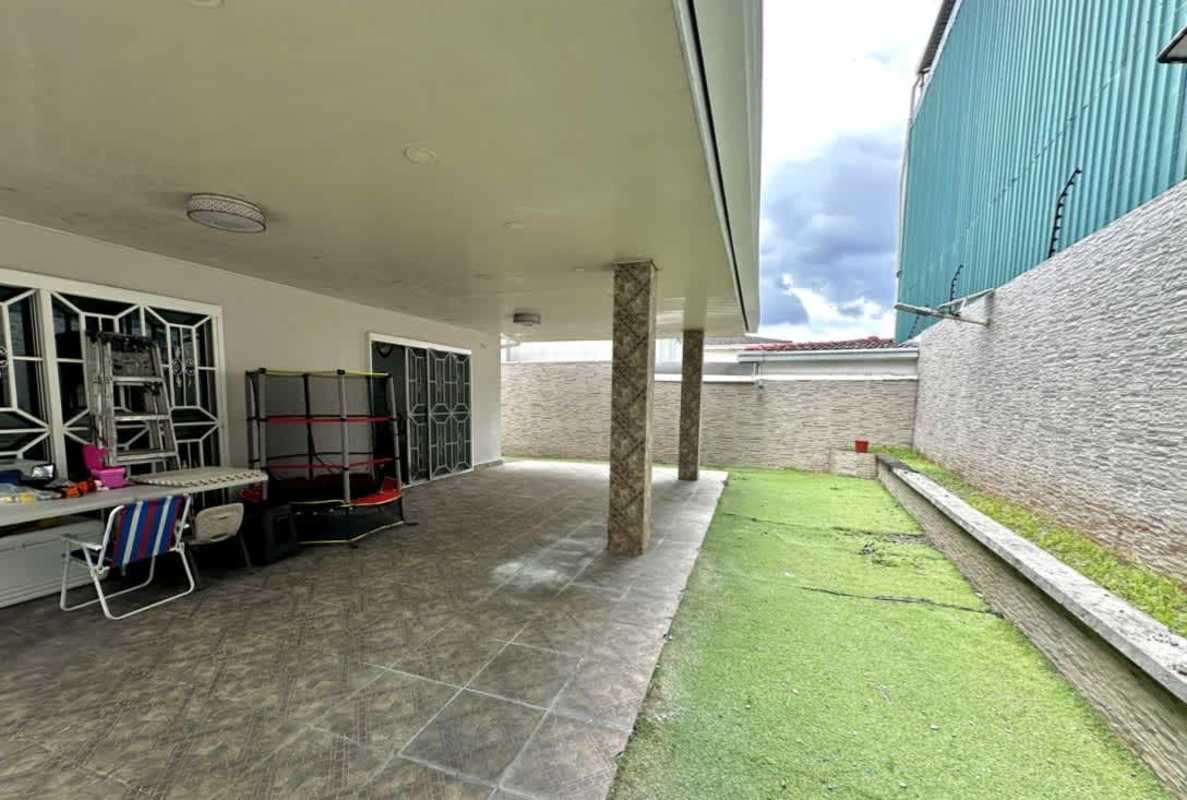 Covered outdoor patio with tiled floor, decorative columns, artificial grass Dorado Village Condado Rey Panama