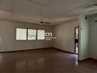 Open living and dining area with kitchen, tile floor, ceiling fans in Coronado beach house Panama