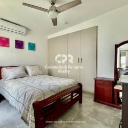 Bedroom with wood furniture, fan, AC and colorful decoration Punta Barco Panama
