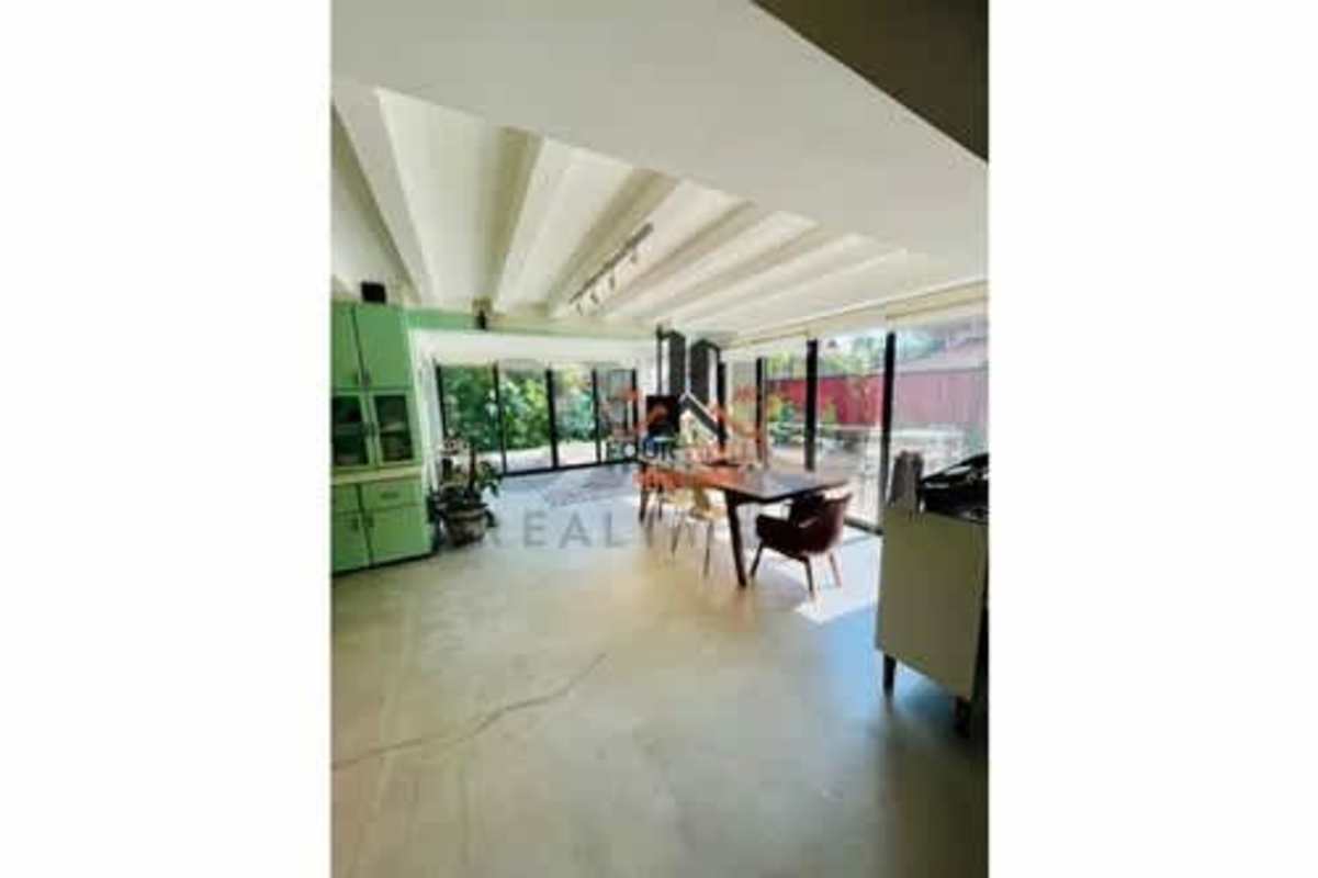 Bright living room with exposed beams and open staircase luxury house Albrook Panama