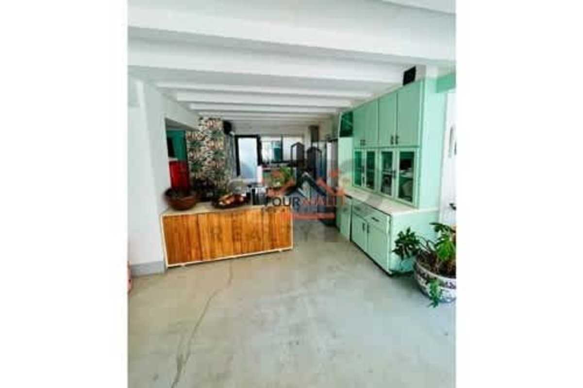 Kitchen with mint green cabinets, island and exposed beams luxury villa Albrook Panama