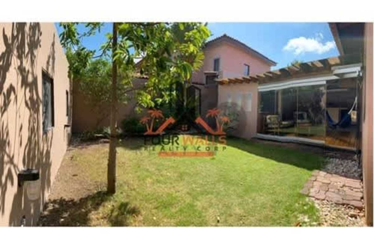 Mediterranean-style facade two-story home with tile roof, large windows and garden in Versalles Panama