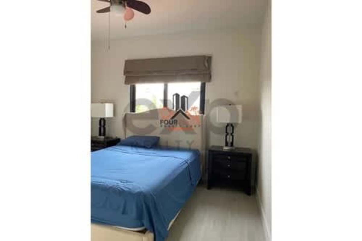 Modern open-plan family room with workspace, stone accent wall and neutral decor in Versalles Panama