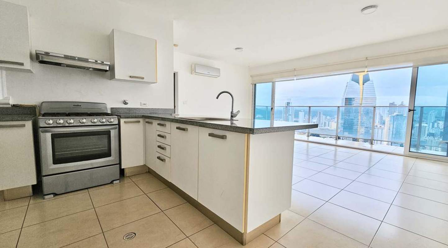 Contemporary kitchen with granite counters and stainless appliances in PH Waters on the Bay Panama City
