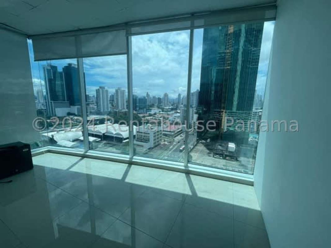 Brightly lit office interior with large windows and skyline view Punta Pacifica