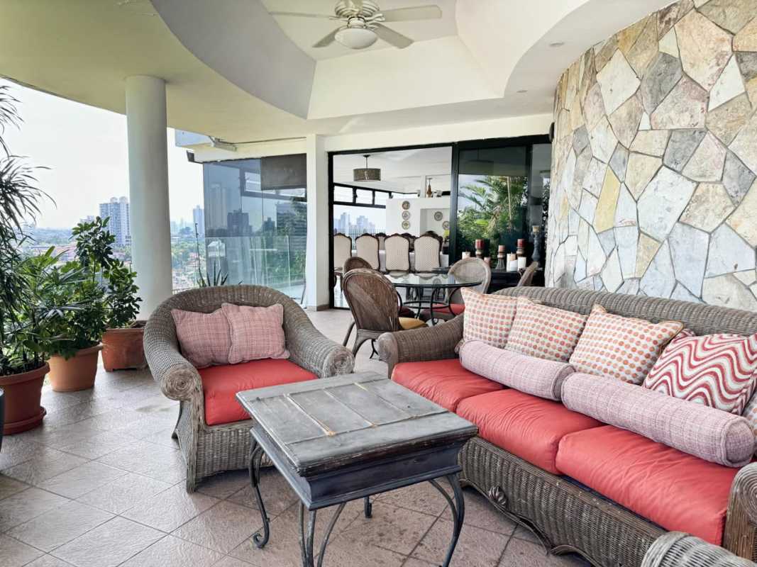 Large covered terrace with wicker furniture panoramic city view Betania home Panama