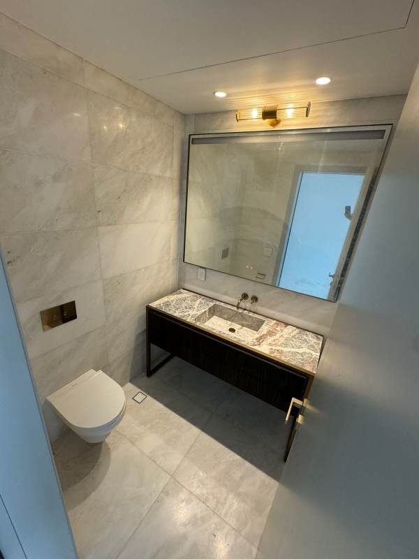 Modern bathroom with marble, freestanding tub and skyline view La Maison by Fendi Santa María