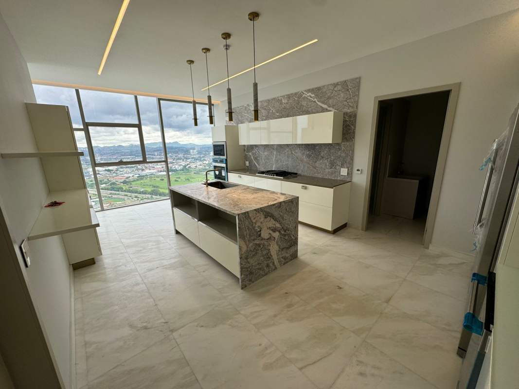 Luxury kitchen with marble countertops, floor-to-ceiling windows and stunning city view in Santa Maria Panama