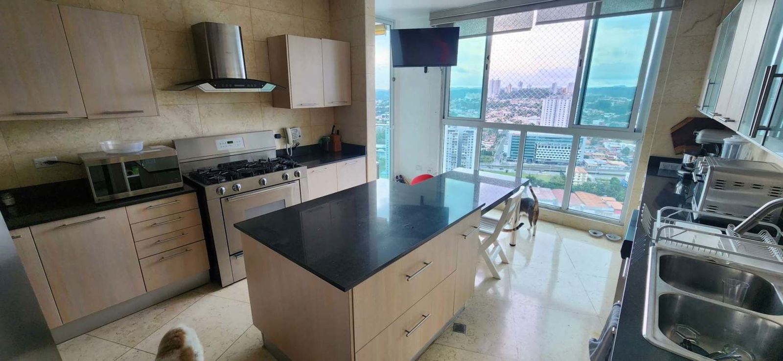 Contemporary kitchen with center island, large windows and city view in PH Hato Pintado Panama