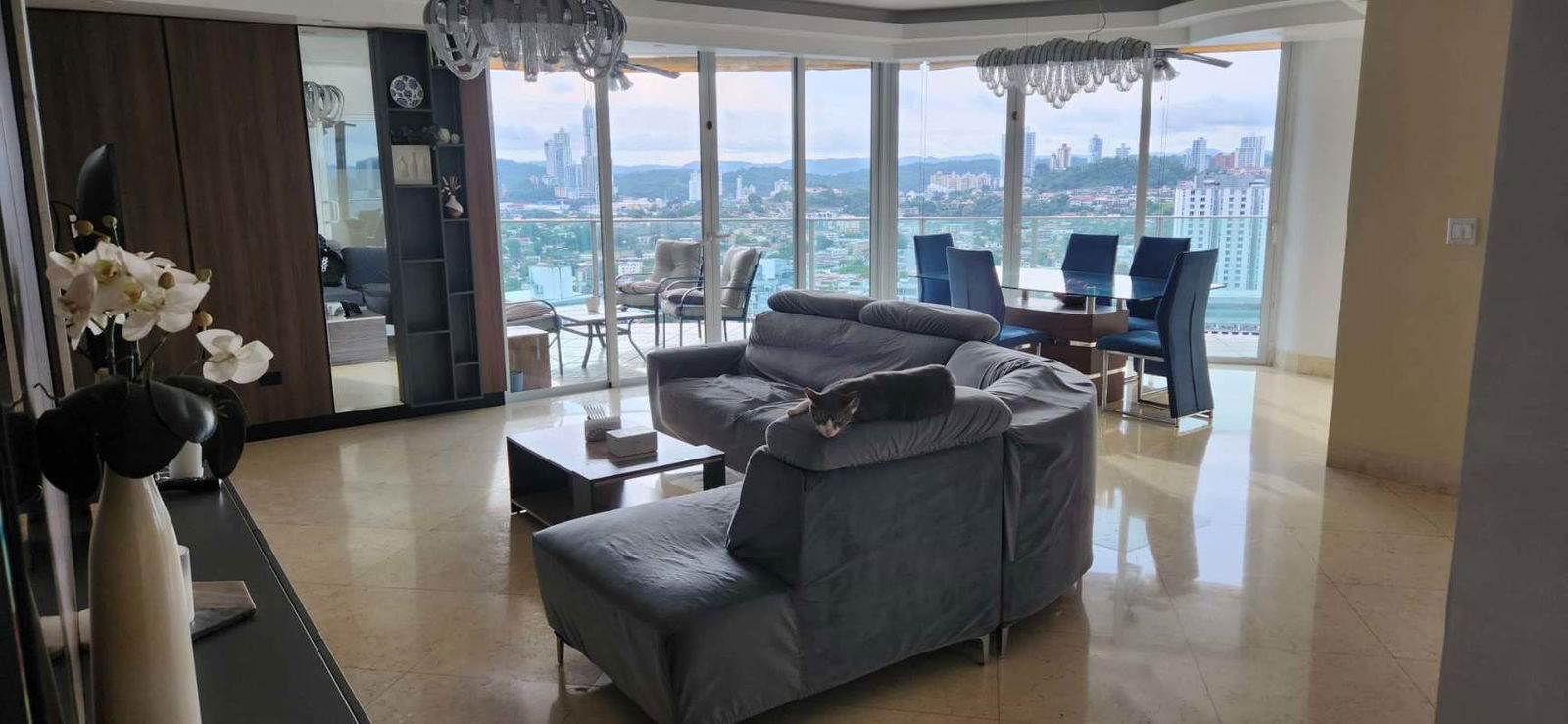 Open plan living dining space with panoramic windows and marble floors at PH Hato Pintado Panama
