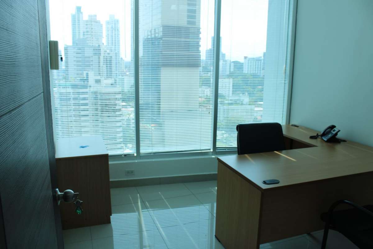 Modern private office with large windows overlooking Panama City skyline