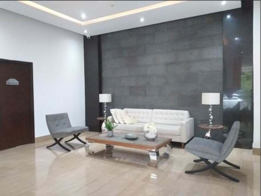 Corner living room with panoramic city skyline floor-to-ceiling windows PH Villa del Mar