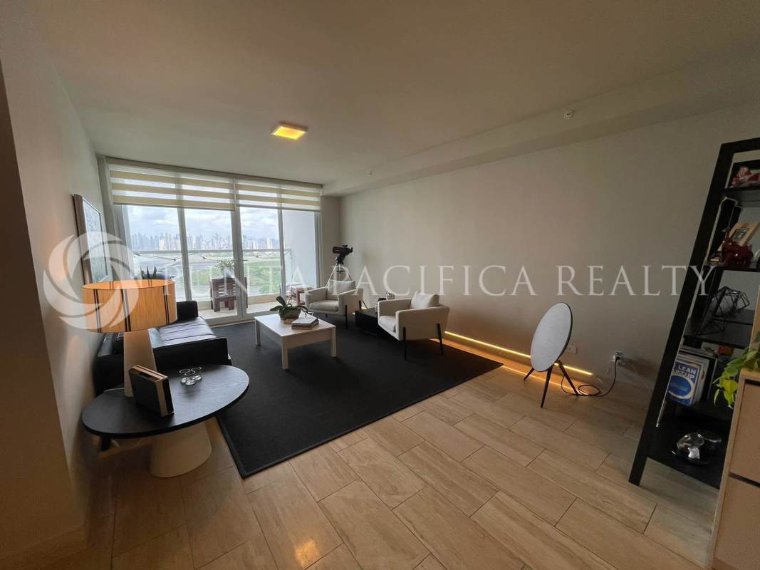 Bright minimalist living room with marble floors, large windows and skyline view at PH Regent Panama City