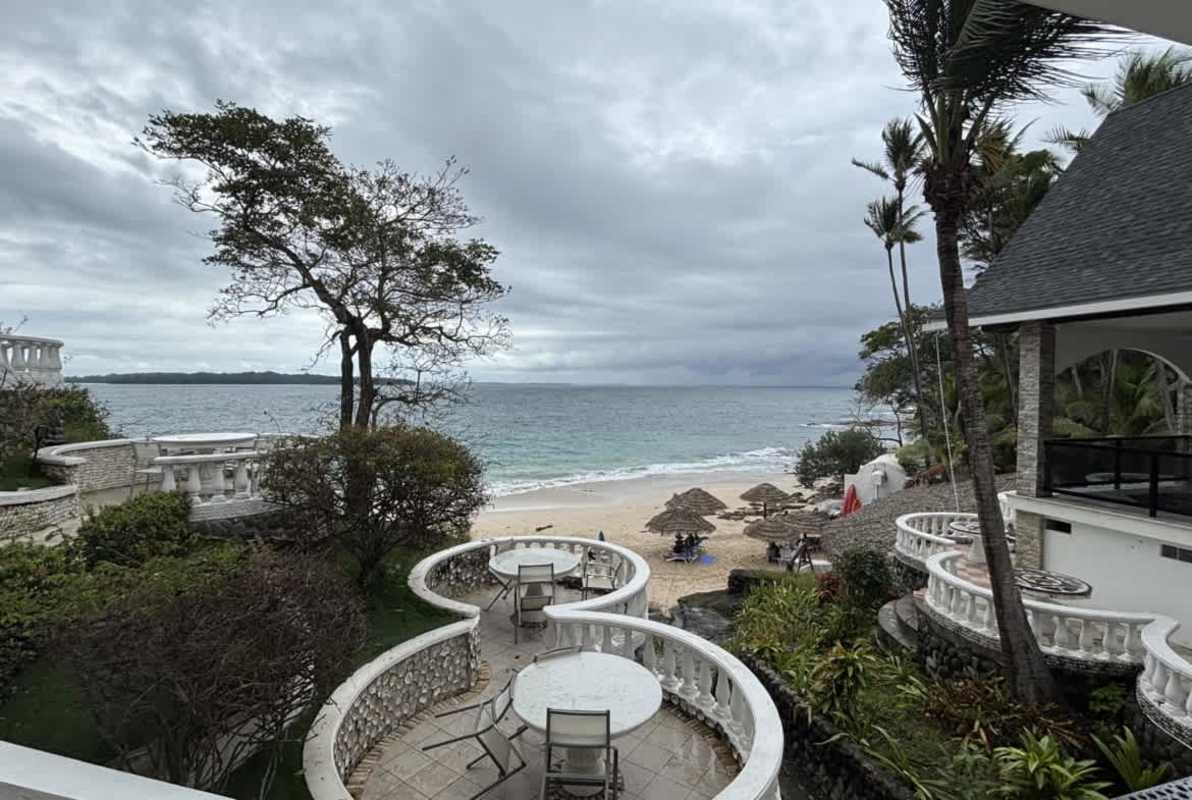 Beachfront Caribbean style resort with palm trees, patios and thatched umbrellas Isla Contadora Panama