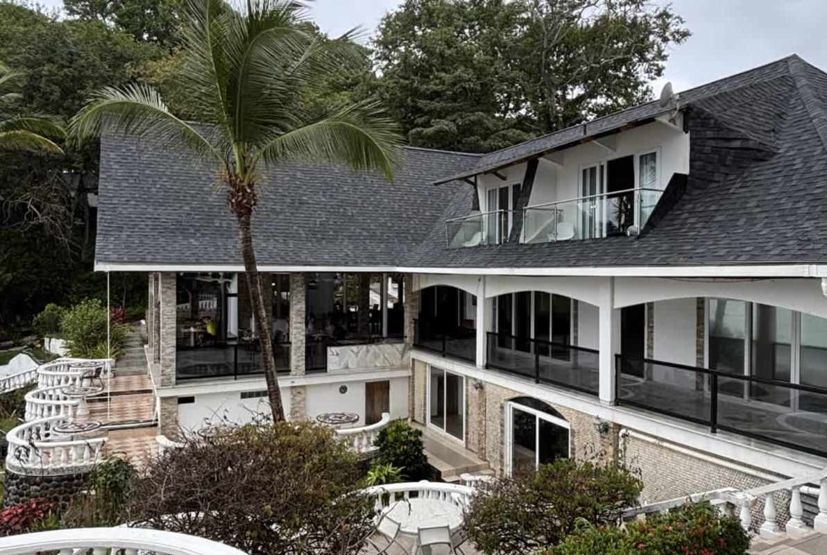 Covered terrace dining area with glass railings overlooking the Pacific Ocean Isla Contadora Panama