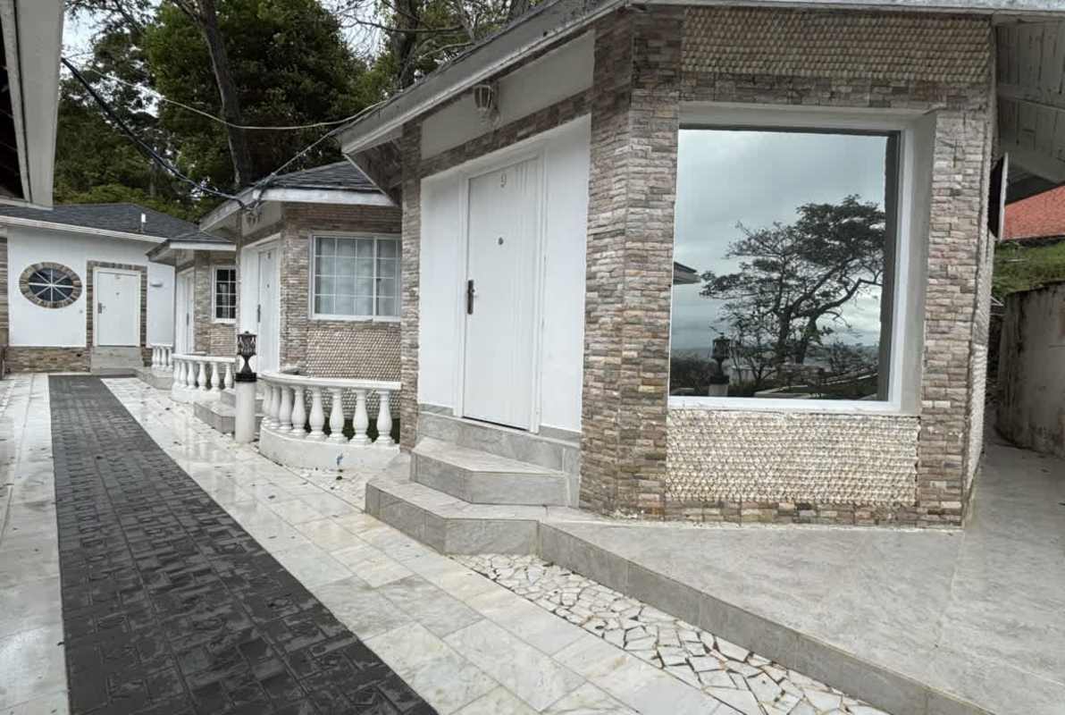 Front stone facade and walkway lined with plants at Isla Contadora boutique hotel Panama