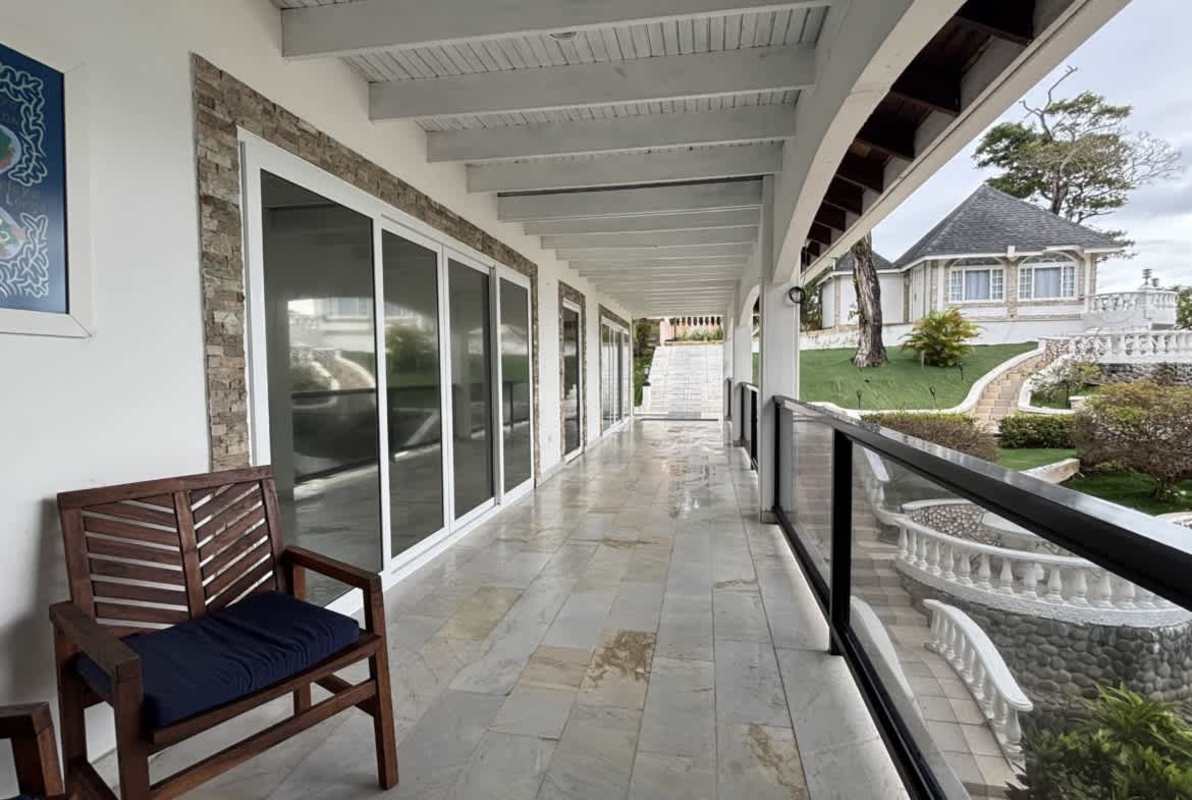 Spacious tile veranda with garden views, glass railings and sliding doors Isla Contadora Hotel Panama