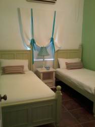 Mediterranean-style apartment building with palm trees and tropical landscaping in Buenaventura Panama