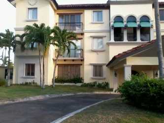 Traditional kitchen with wood cabinets, tile counters, microwave in PH Los Portales Buenaventura Panama