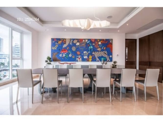 Large living and dining area with floor-to-ceiling windows overlooking the ocean at PH Marea II Costa del Este Panama