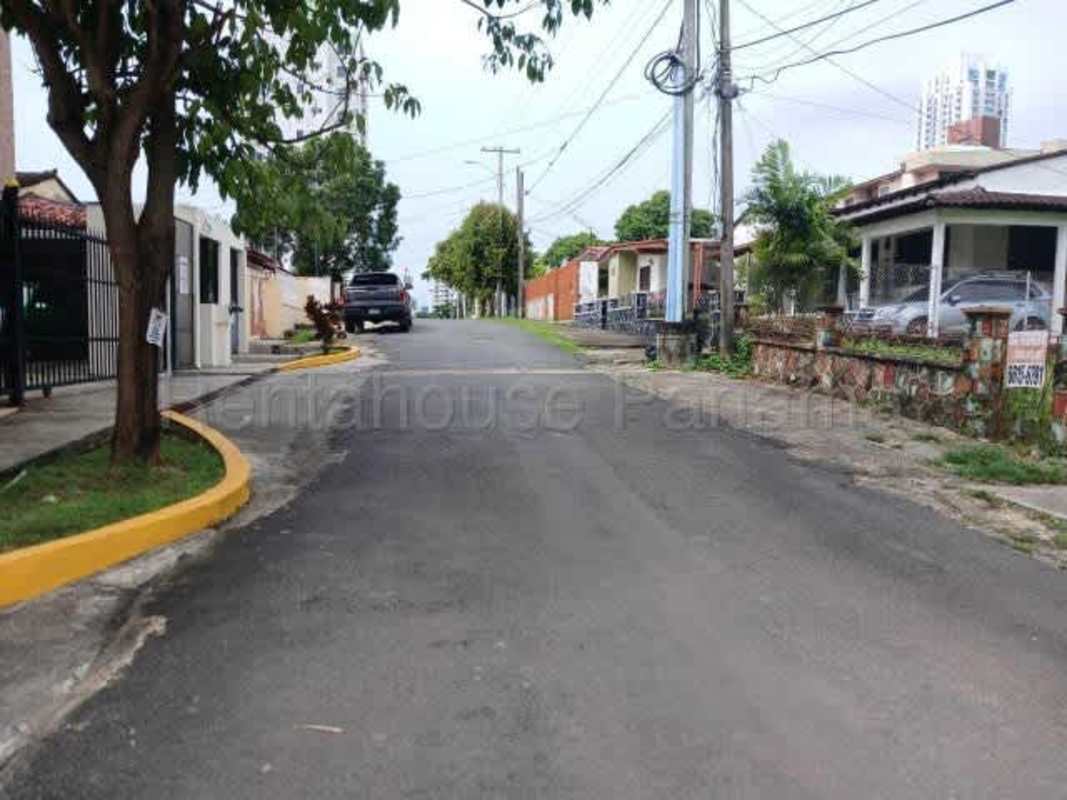 Flat urban lot bordered by wall and high-rise residential buildings in Carrasquilla Panama