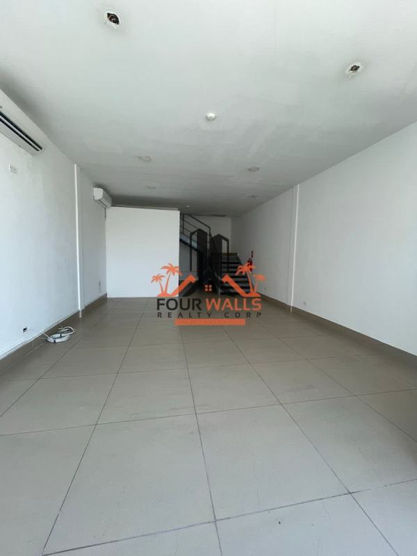 Bright empty commercial space with tiled flooring, white walls, large street-facing window in San Francisco Panama