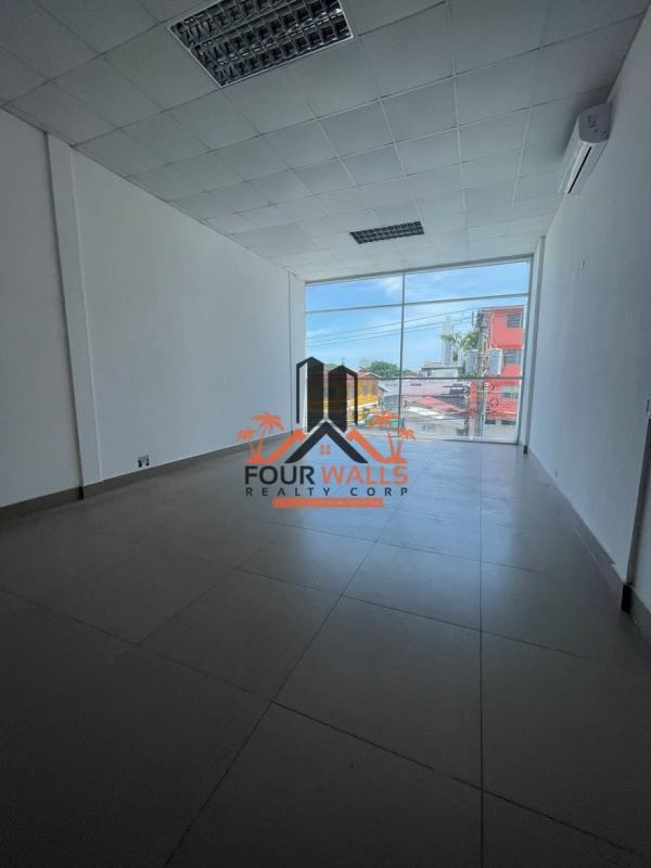 Modern black facade commercial plaza with patio seating and glass storefront in San Francisco Panama City