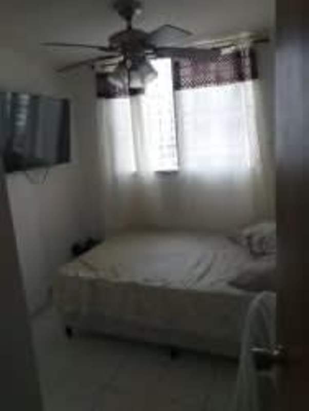 Bedroom with closet space and tiled floors in affordable apartment Residencial Parque del Este Don Bosco Panama City