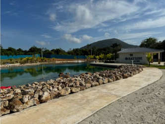 Man-made lagoon beach club with tropical landscaping in Playa Dorada Vacamonte Panama