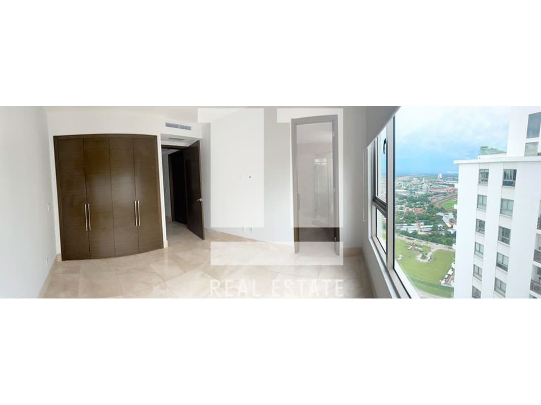 Bedroom with large window city view, dark wood wardrobe, marble flooring in PH Green Garden Panama