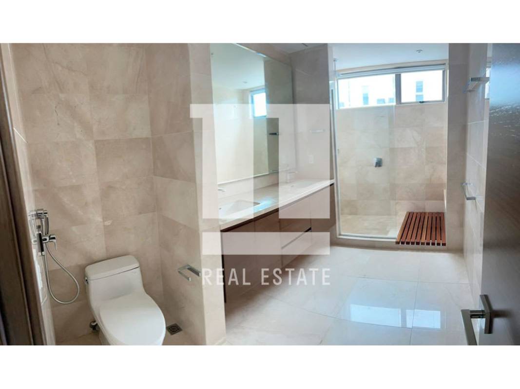 Elegant bathroom with double vanity, large mirror, glass-enclosed shower in PH Green Garden Santa Maria Panama