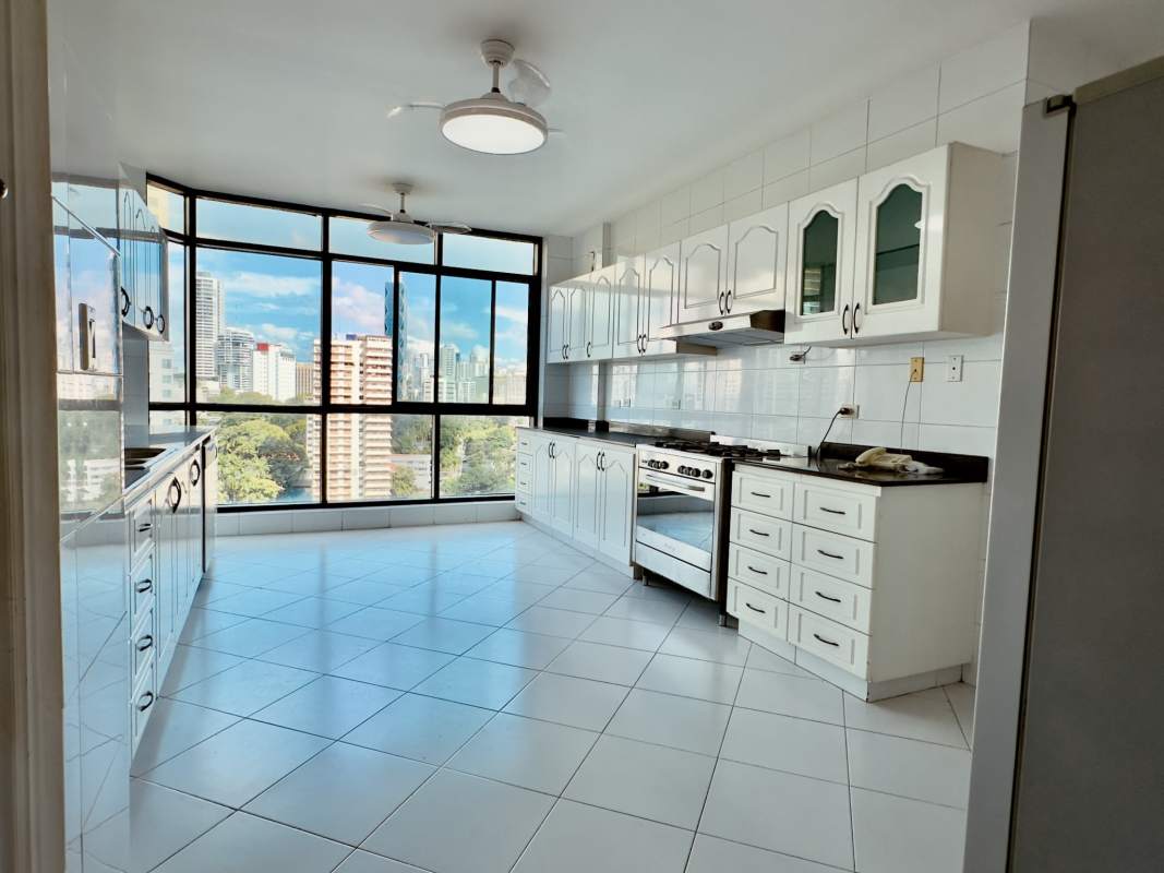 Elegant marble bathroom with corner tub floor-to-ceiling glass windows at PH Miramar Plaza Panama City