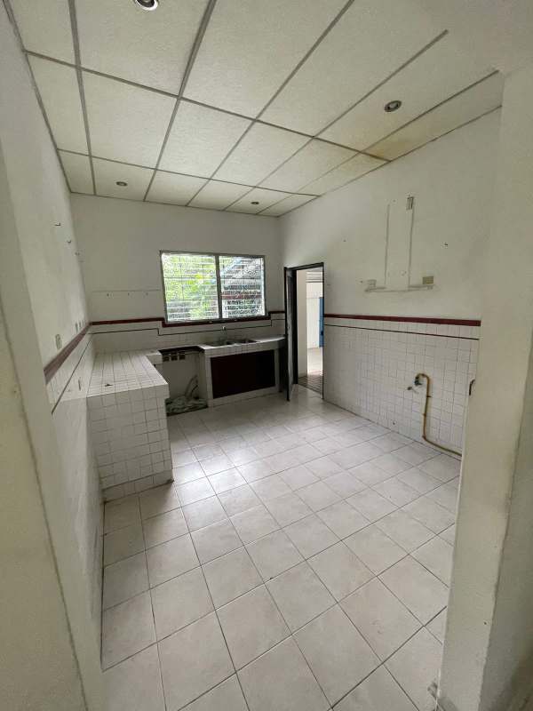 Simple tiled kitchen with countertop, sink, window San Francisco commercial property Panama
