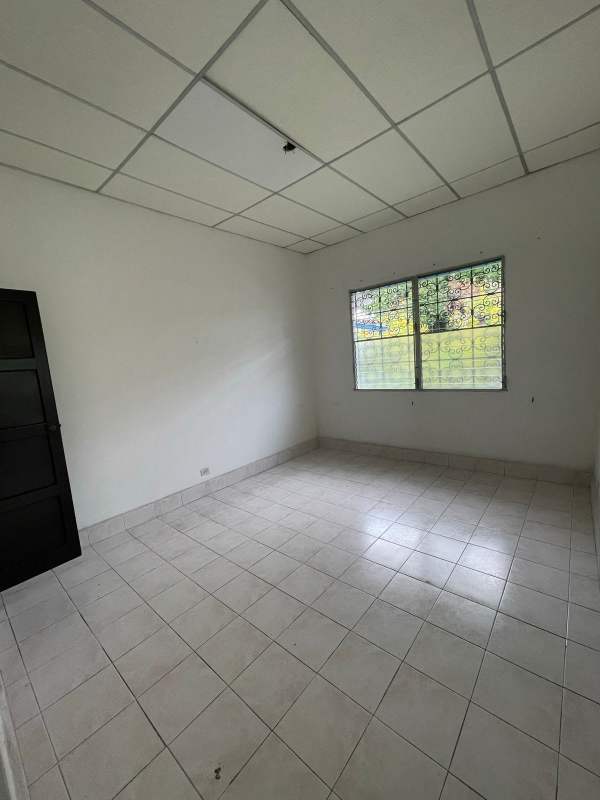 Empty bedroom with tiled floor barred window commercial development lot Panama City