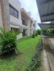 Contemporary two-floor apartment complex with green lawn and balconies in David Panama