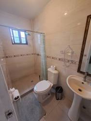 Full bathroom with glass shower enclosure and modern fixtures central David Panama apartment