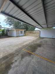 Covered resident parking and main entrance of rental apartment building in David Chiriquí
